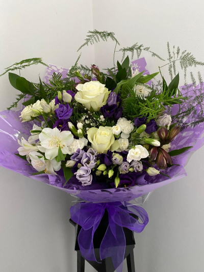 Lavender Elegance Hand-Tied - A beautifully balanced hand-tied bouquet featuring soft, calming tones paired with fresh greenery for a natural, airy finish. Thoughtfully arranged and wrapped in elegant packaging, this design offers a graceful and timeless look that suits any occasion.

Perfect for celebrating special moments or sending a thoughtful gesture, this bouquet brings a sense of calm, beauty, and understated sophistication to any setting.