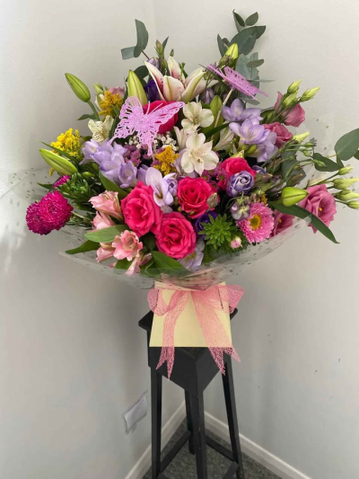 Enchanted Garden Hand-Tied - A beautifully whimsical hand-tied bouquet filled with soft colour tones and playful detail, designed to capture a sense of charm and delight. Finished with elegant wrapping and a delicate decorative touch, this arrangement creates a light, airy feel with a hint of magic.

Perfect for birthdays, celebrations, or making someone feel truly special, this bouquet is full of character and designed to leave a lasting impression.