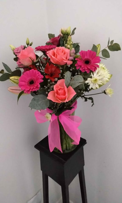 Pretty Pink Vase Arrangement - A bright and joyful arrangement presented in a clear vase and finished with a vibrant ribbon for an extra touch of charm. With its lively pink tones, soft contrasting accents, and fresh greenery, this design creates a cheerful and elegant display that’s ready to enjoy straight away.

Perfect for birthdays, thank you gifts, or simply brightening someone’s day, this arrangement brings colour, warmth, and a lovely sense of celebration to any space.
